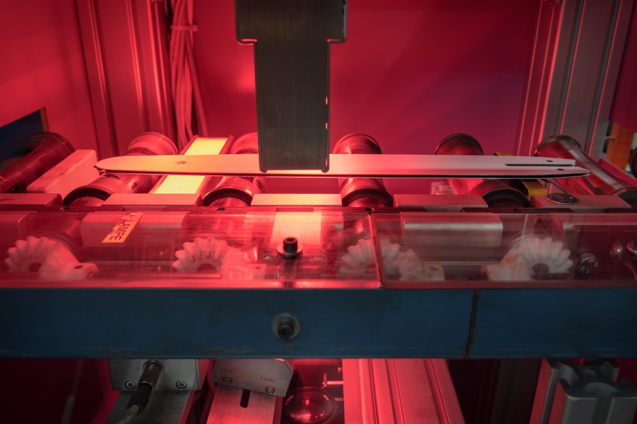 Machine in de productie van zaagbladen die het boren van oliegaten en het lakwerk uitvoert